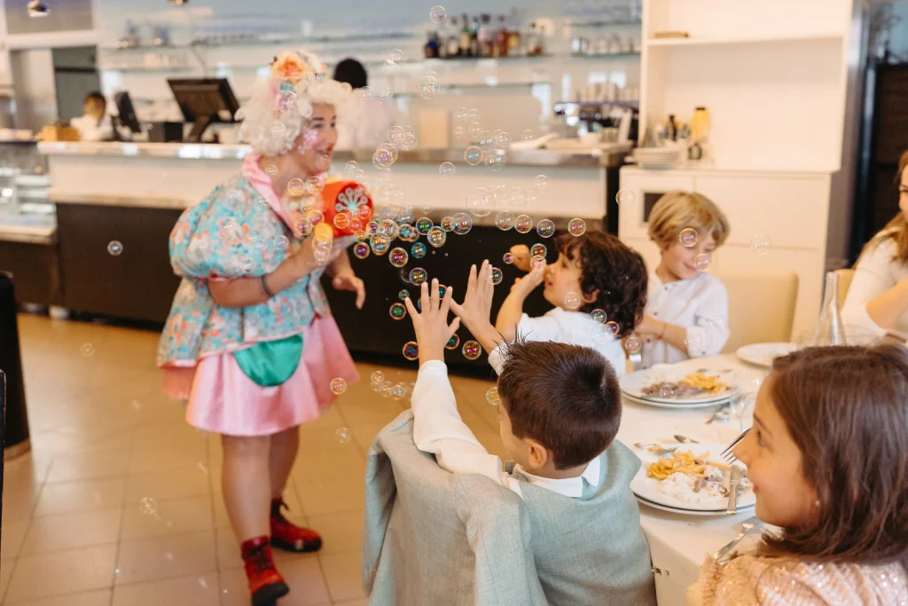 Children enjoying a fun entertainment show with bubbles at a party in Lisbon, Portugal.