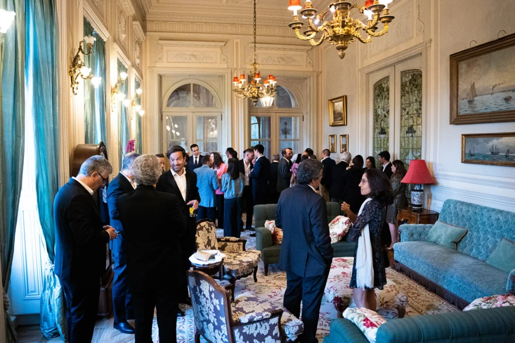 A lively corporate event in Lisbon with guests enjoying live music, drinks, and an elegant atmosphere.