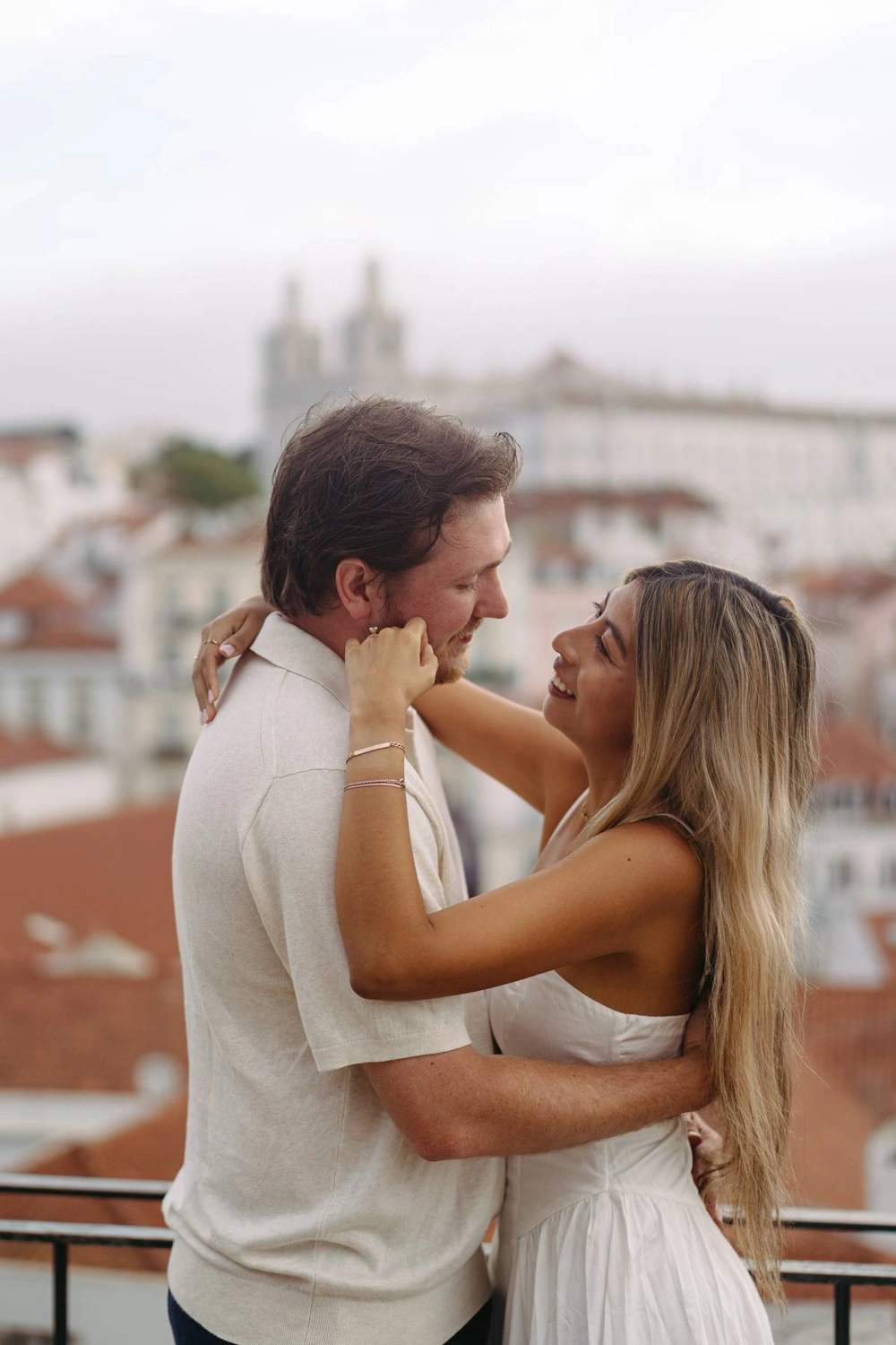 A couple gazes into each other’s eyes on a Lisbon terrace, capturing the essence of their love story.