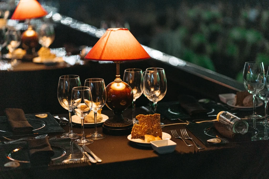 A sophisticated table setting with wine glasses and ambient lighting, perfect for an exclusive event dinner in Portugal