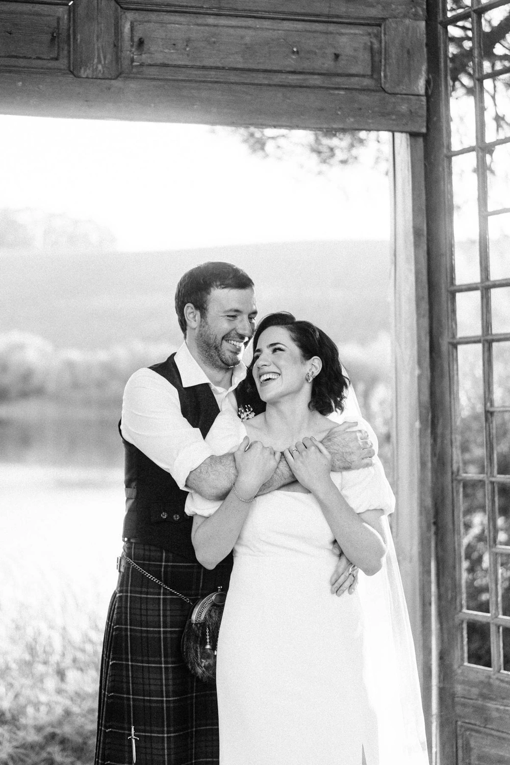 Bride and groom embrace in a romantic black-and-white portrait, capturing timeless love at their Portugal wedding