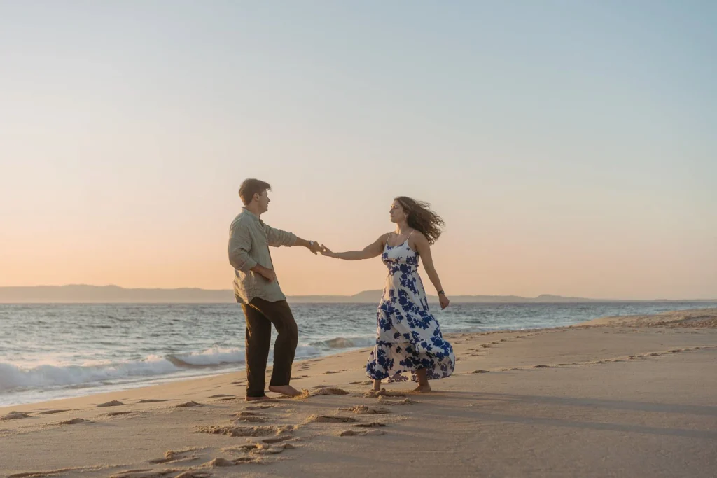 Engagement proposal on a sandy beach with ocean waves in portugal.