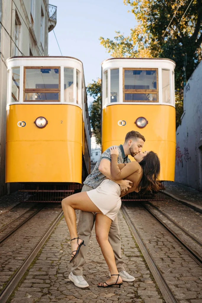 A romantic engagement session in Lisbon, featuring a couple posing with the city’s famous yellow trams.