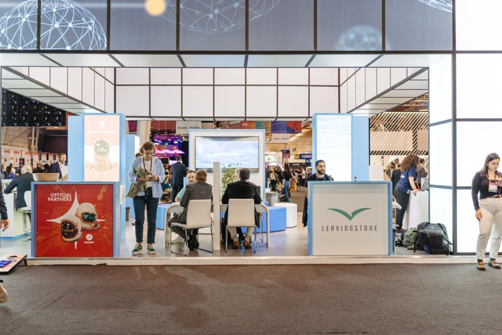 Modern exhibition booth at a corporate networking event in Portugal, showcasing branding and interactive displays in websummit