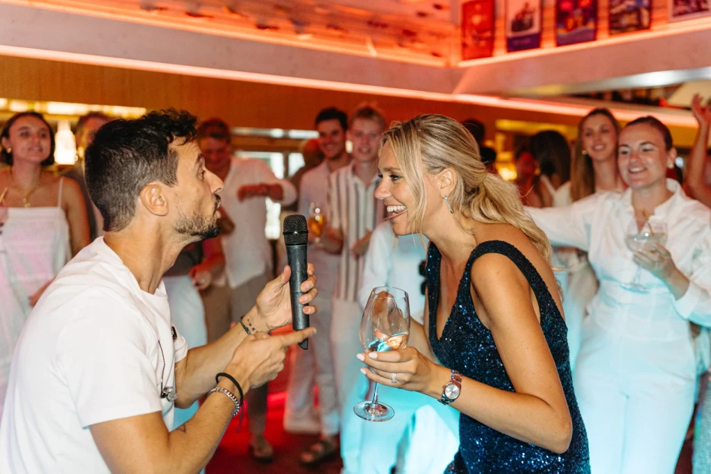 A lively indoor party scene with guests dancing and sharing a fun moment on the dance floor.