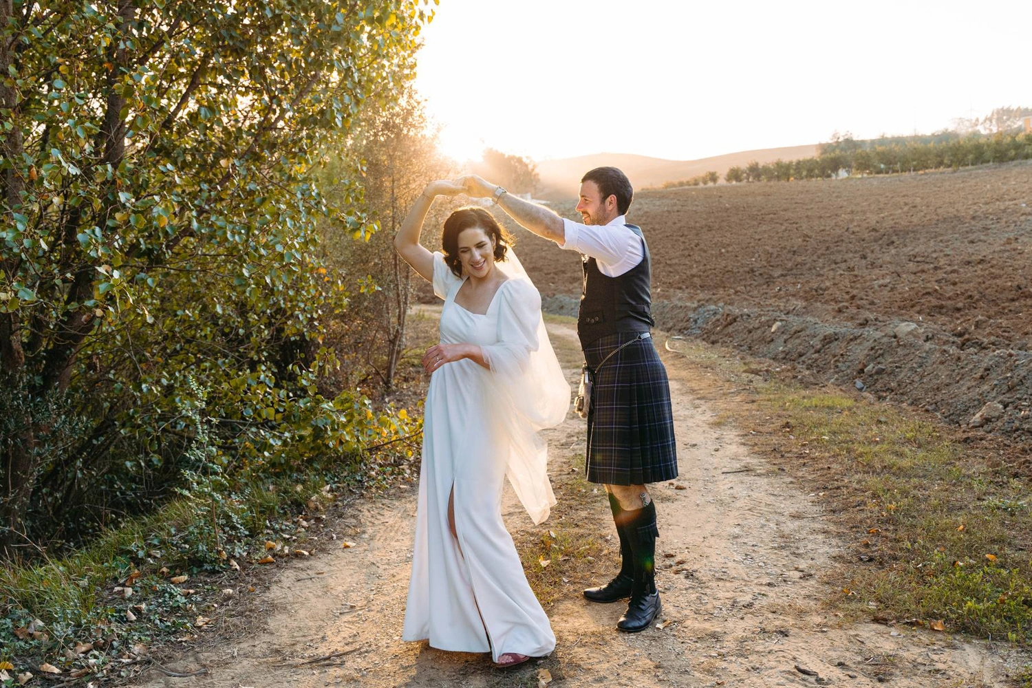 Bride and groom standing in a romantic embrace in a forest with golden leaves in a intimate in Quinta da Bichinha