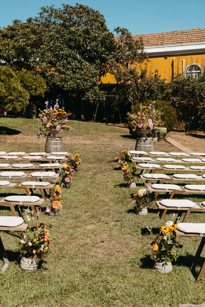 A charming chalkboard wedding welcome sign with the couple's names against a rustic yellow wall at Quinta de Sant'Ana.