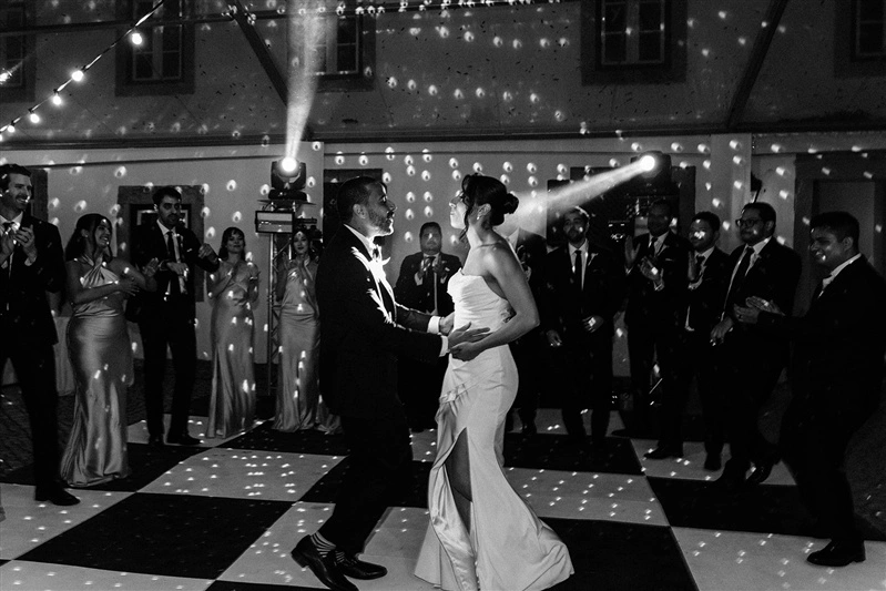 Black and white photo of bride and groom sharing their first dance at a romantic Portugal wedding reception.
