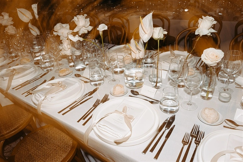 Elegant wedding reception table setup with white florals and modern decor at a luxury Portugal wedding venue.