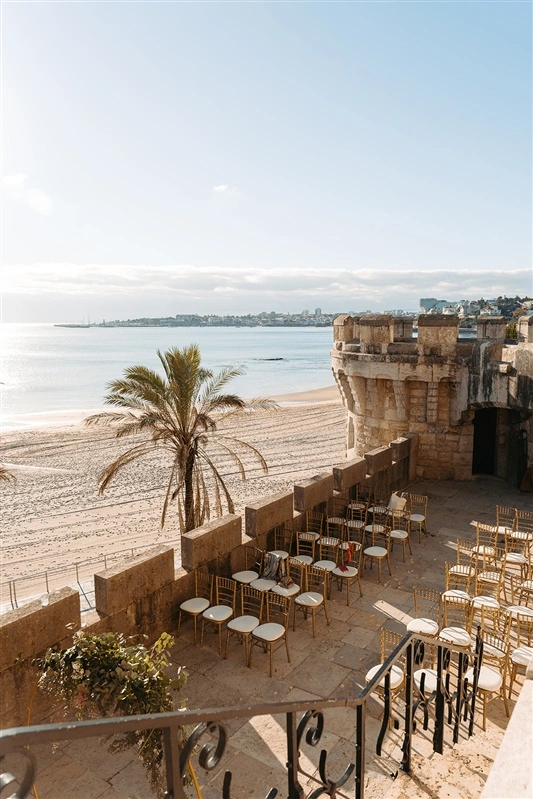 Seafront ceremony setup at Forte da Cruz in Estoril overlooking the Atlantic Ocean.