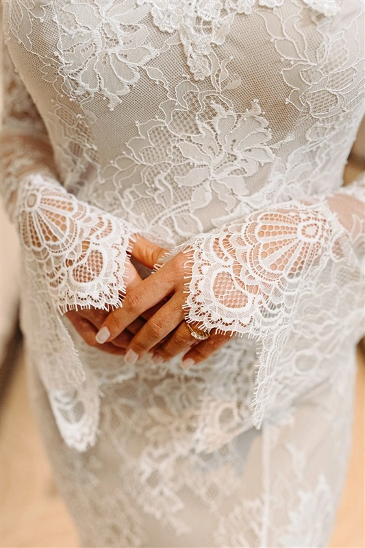 Detailed lace wedding dress during winter bridal preparations at a luxury Lisbon hotel.