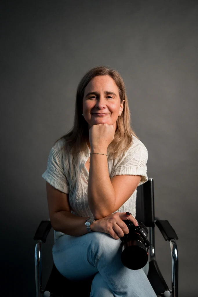 Professional portrait of a wedding and lifestyle photographer looking thoughtful and confident in natural light