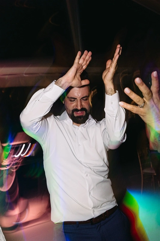 Energetic groom dancing at Portugal destination wedding reception
