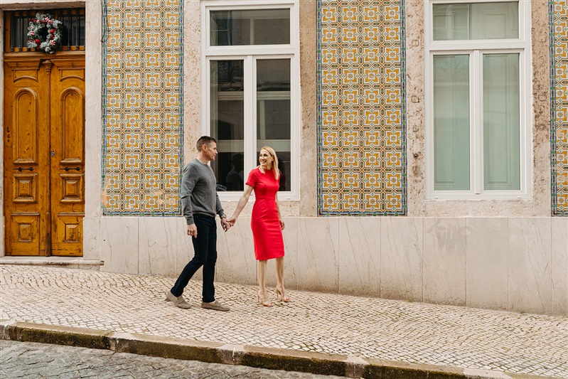 Couple walking hand in hand beside traditional Portuguese tiles during a Lisbon photoshoot SONIA + BRIAN -52.jpg romantic-couple-photo-session-lisbon-viewpoint.jpg Couple sharing a romantic moment overlooking a Lisbon street with a yellow tram passing by SONIA + BRIAN -53.jpg elegant-couple-portrait-lisbon-church.jpg Elegant couple portrait in front of a historic church during a Lisbon photography session SONIA + BRIAN -69.jpg couple-date-night-photo-session-lisbon-cafe.jpg Couple enjoying a cozy date night moment inside a Lisbon café during their photo session SONIA + BRIAN -75.jpg fun-couple-photo-lisbon-pastry-shop.jpg Couple sharing a pastel de nata during a fun and candid Lisbon couple photo session SONIA + BRIAN -79.jpg candid-couple-photo-session-lisbon-coffee-shop.jpg Candid couple sitting together in a charming coffee shop during a Lisbon couples photoshoot